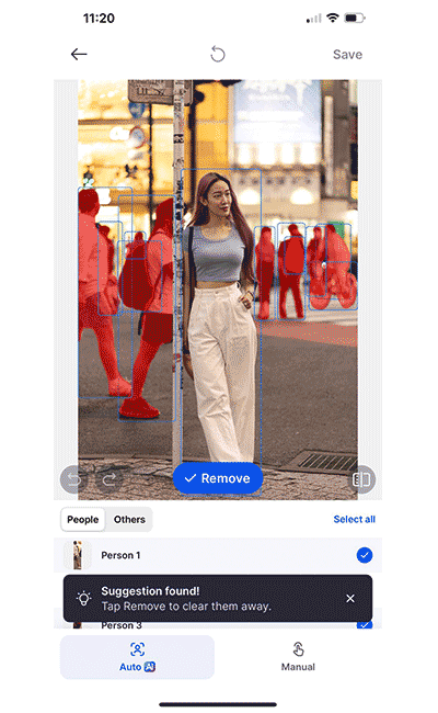 Girl taking photo at a busy intersection